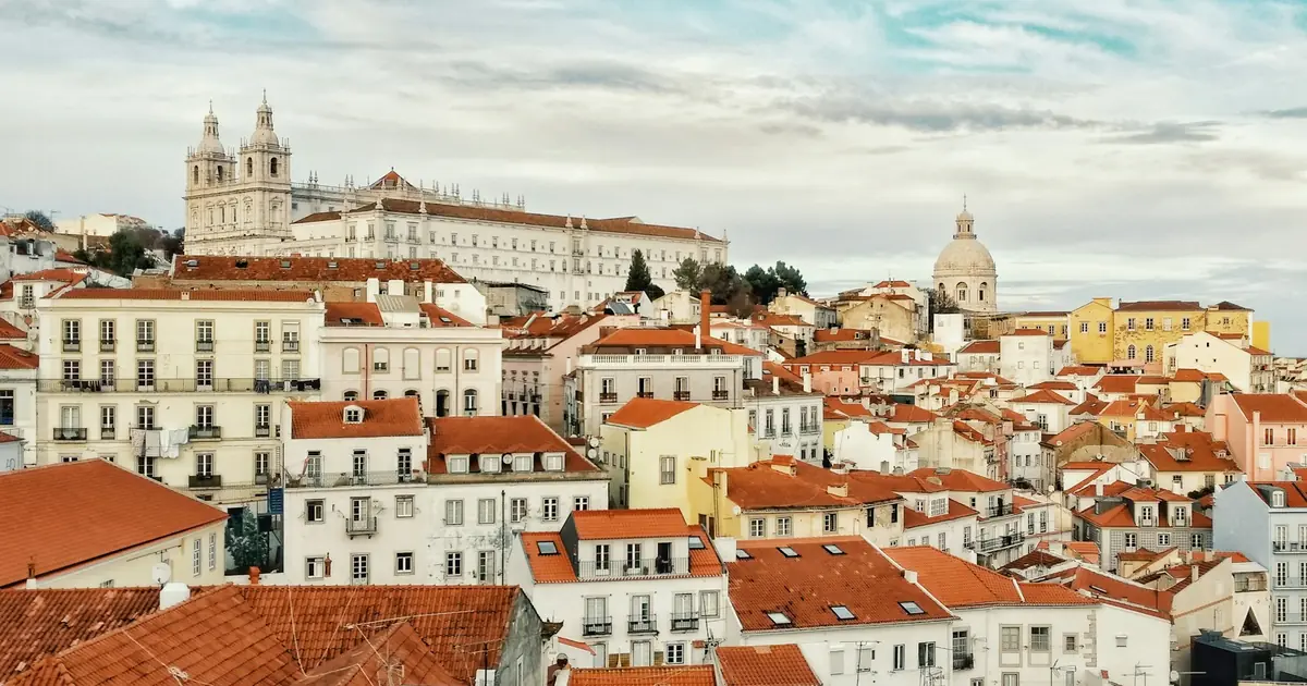 Red rooftops and white buildings of the Alfama district in Lisbon, Portugal