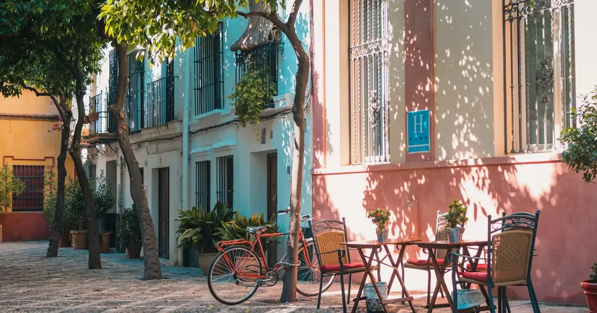 A café street with a bicycle parked outside in Seville, Spain