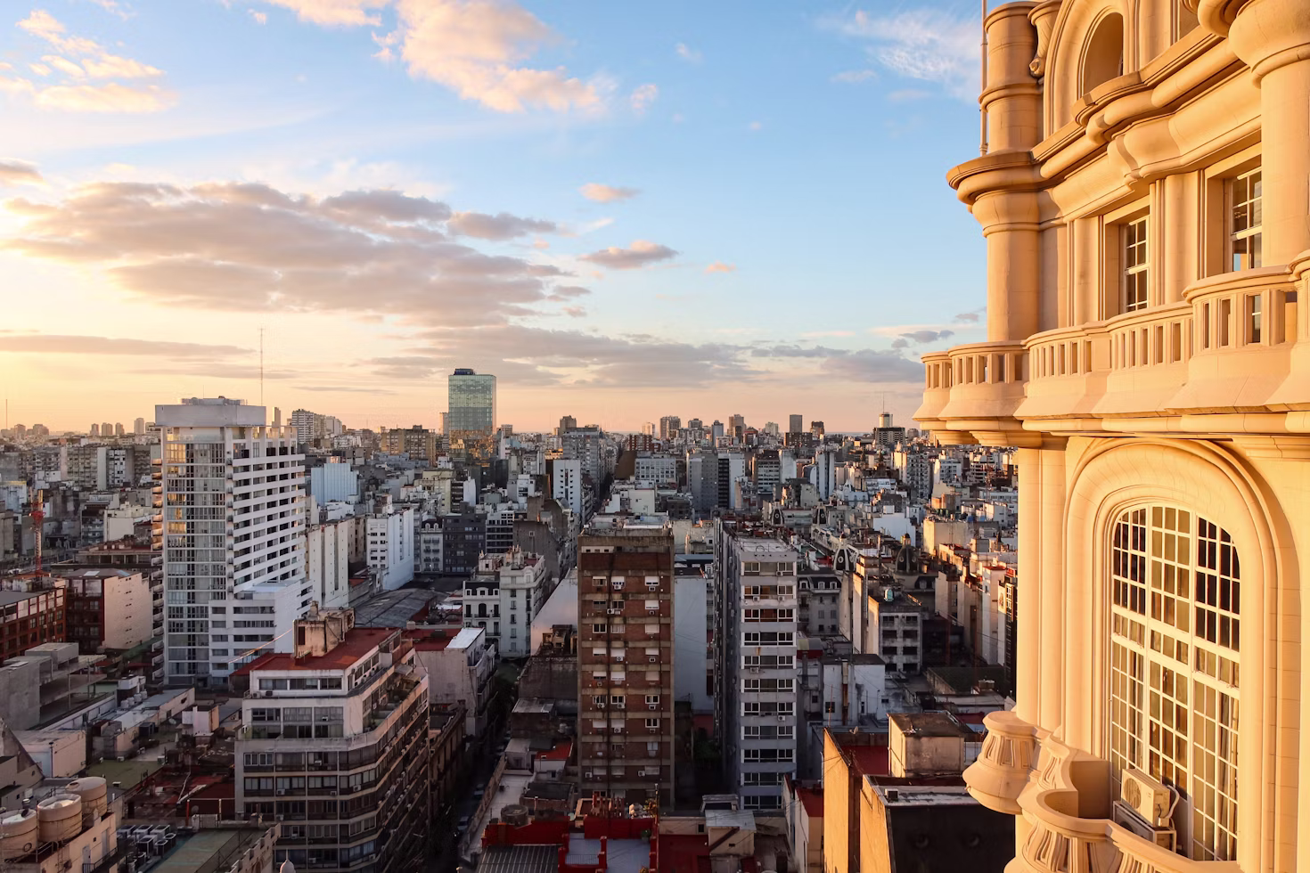 Buenos Aires skyline at sunset beside an ornate building facade, Argentina