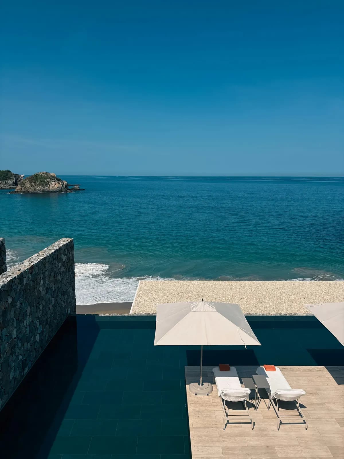 An infinity-pool terrace overlooking a beach on Mexico's Pacific coast