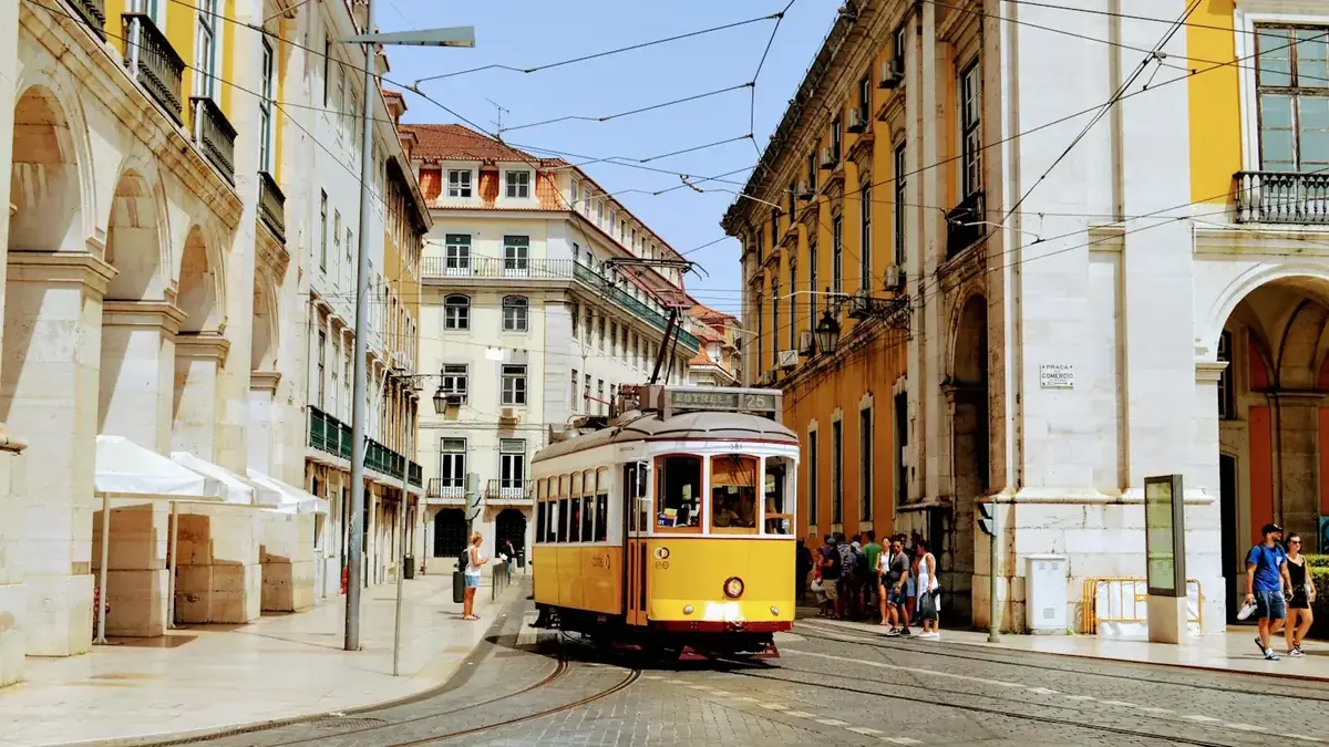 Yellow tram on a street in Lisbon's Baixa district, Portugal, where Americans now pay tax under the 1994 US-Portugal treaty since NHR closed