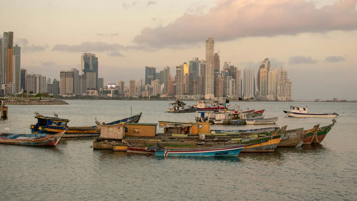 Panama City skyline across the Bay of Panama with fishing boats in the foreground, Panama