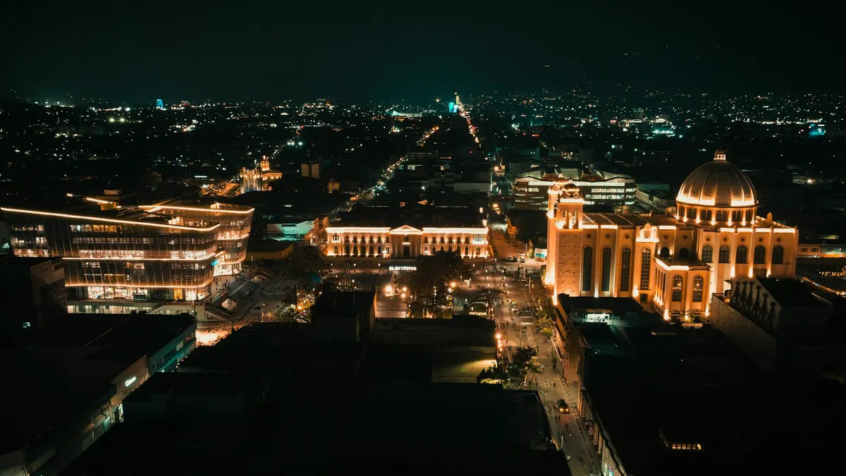 San Salvador's historic center at night with the Metropolitan Cathedral dome and National Palace lit up, El Salvador